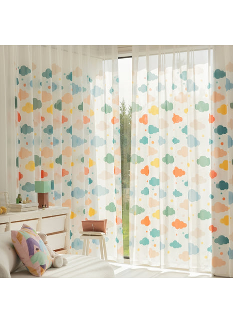 a bedroom with a white bed and a colorful curtain