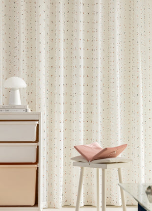 a room with a chair and a table with a vase on it