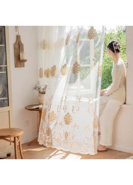 a woman sitting on a window sill looking out the window