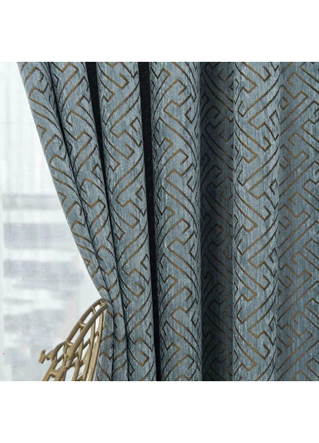 a close up of a curtain with a chair in front of it