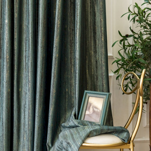 a picture frame sitting on a chair next to a curtain