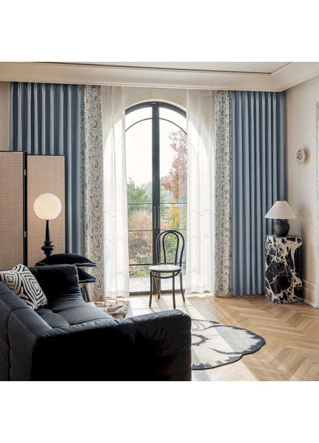 a living room filled with furniture and a large window