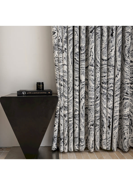 a black and white curtain next to a black table