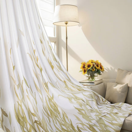 sunflowers in a vase on a table in front of a curtain