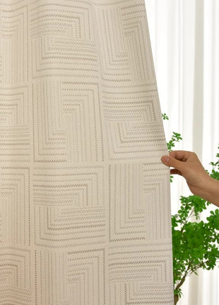 a person holding up a curtain in front of a plant