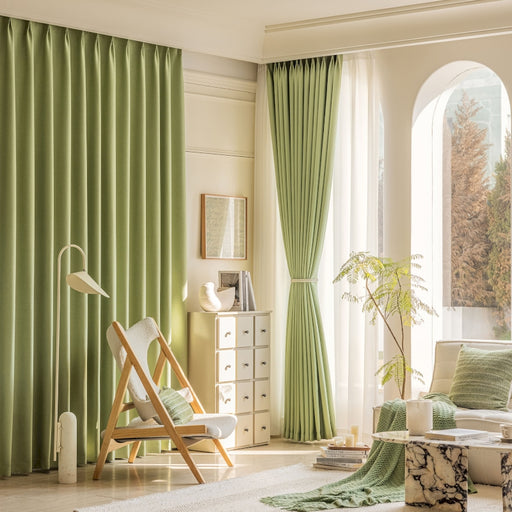 a living room filled with furniture and green curtains