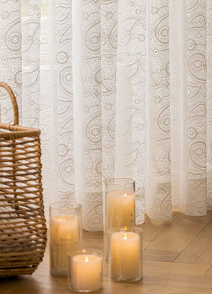 a group of candles sitting on a wooden floor next to a window