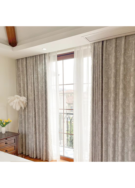 a bedroom with a bed and a window with curtains