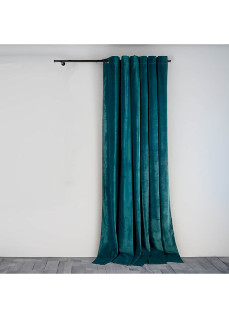a green curtain hanging on a white wall