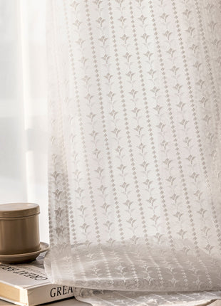 a coffee cup sitting on top of a book next to a window