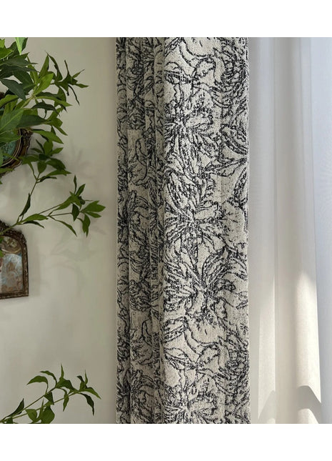 a plant is hanging on a wall next to a curtain