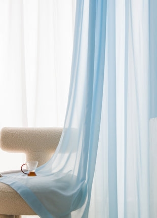 a white chair with a light blue drape on it