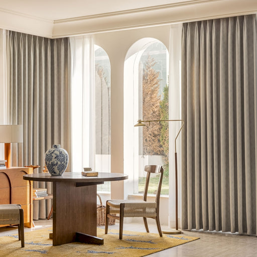 a living room with a table and chairs