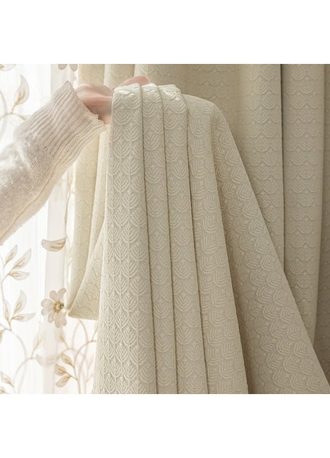 a person holding a curtain in front of a window