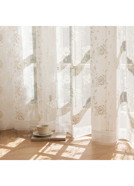 a cup and saucer sitting on a table in front of a window
