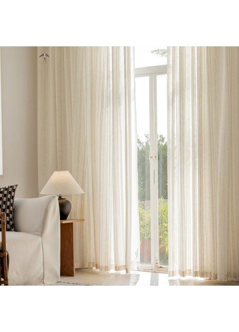 a living room with a white couch and a large window