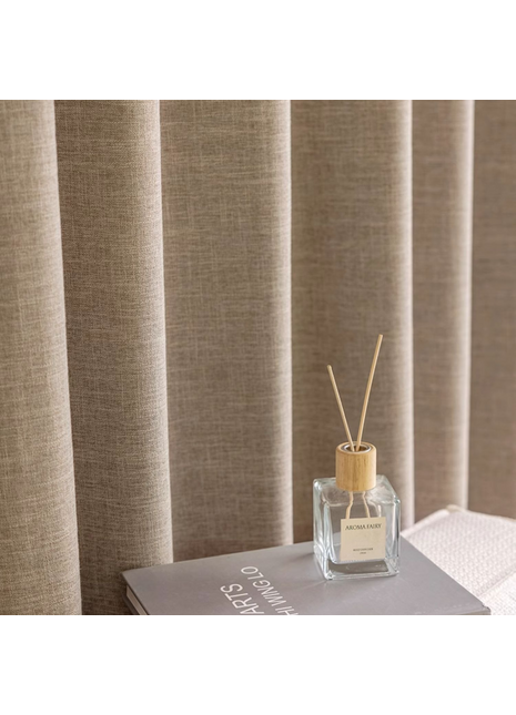 a bottle of perfume sitting on top of a book
