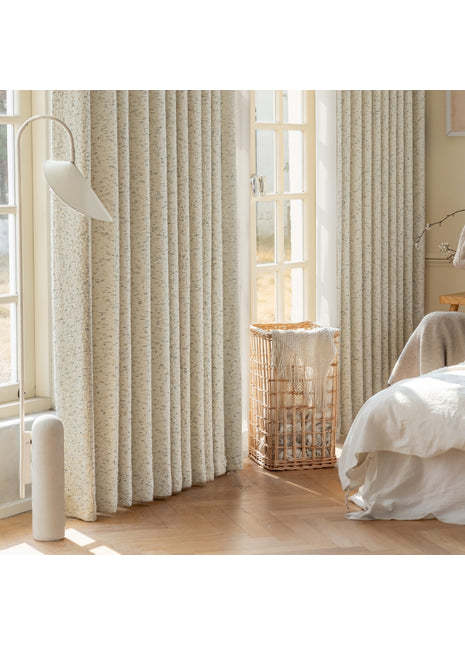a bedroom with a bed and a window with curtains