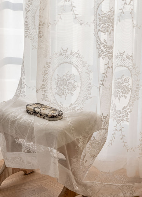 a white chair sitting in front of a window