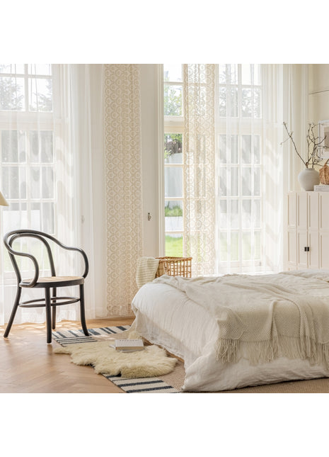 a bedroom with a bed and a chair in it
