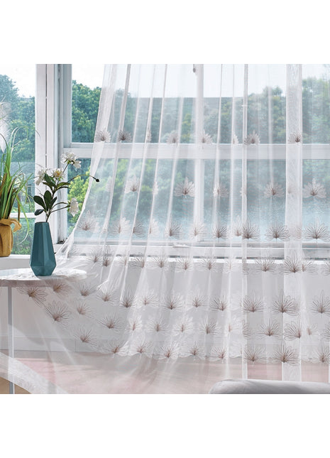 a window with a sheer curtain and a vase with flowers