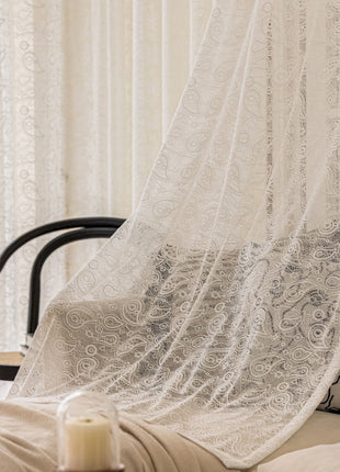 a bed with a white curtain over it