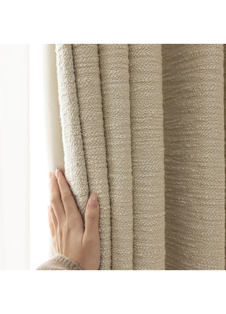a person is holding a curtain with their hand