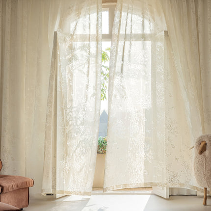 a living room with a chair and a window