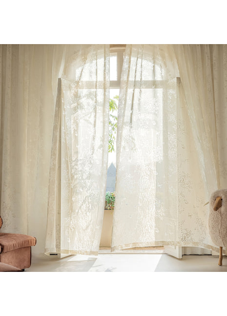 a living room with a chair and a window