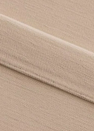 A close-up view of a fabric with a diagonal crease running across it.