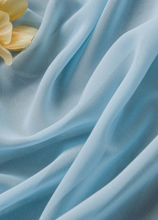 a yellow flower sitting on top of a blue cloth