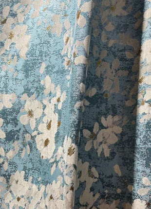 a close up of a blue and white flowered fabric