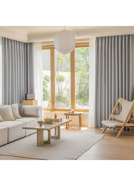 a living room filled with furniture and a large window