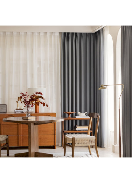 a living room with a table a chair and a window