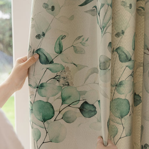 a person is opening the curtains with their hand