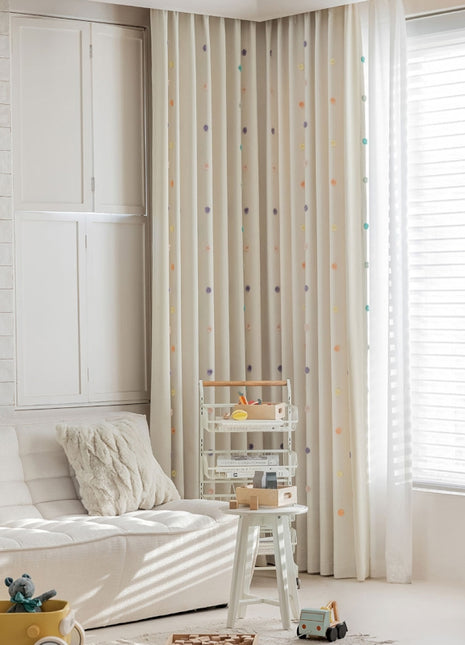 a living room with a white couch and white curtains