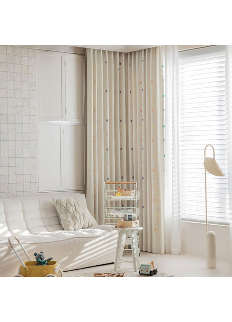 a living room with a white couch and white curtains