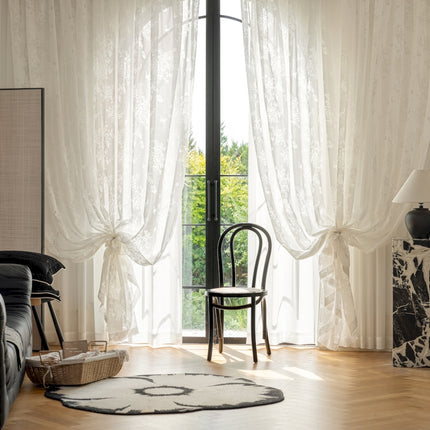 a living room with a chair and a rug