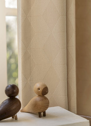 a couple of wooden birds sitting on top of a table