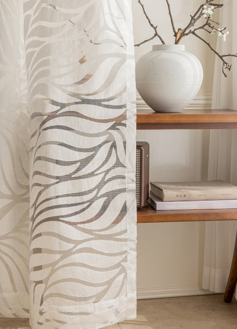 a white vase sitting on top of a wooden shelf