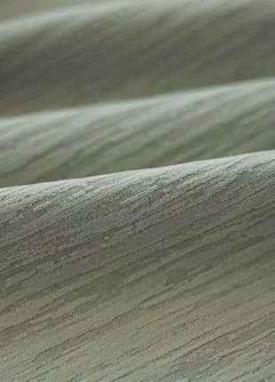 Gros plan sur les stries verticales du tissu vert en chenille