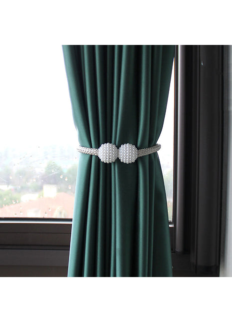 Rideau vert avec deux boules blanches, ajoutant une touche décorative à l'intérieur. Idéal sur Rideaux Déco.